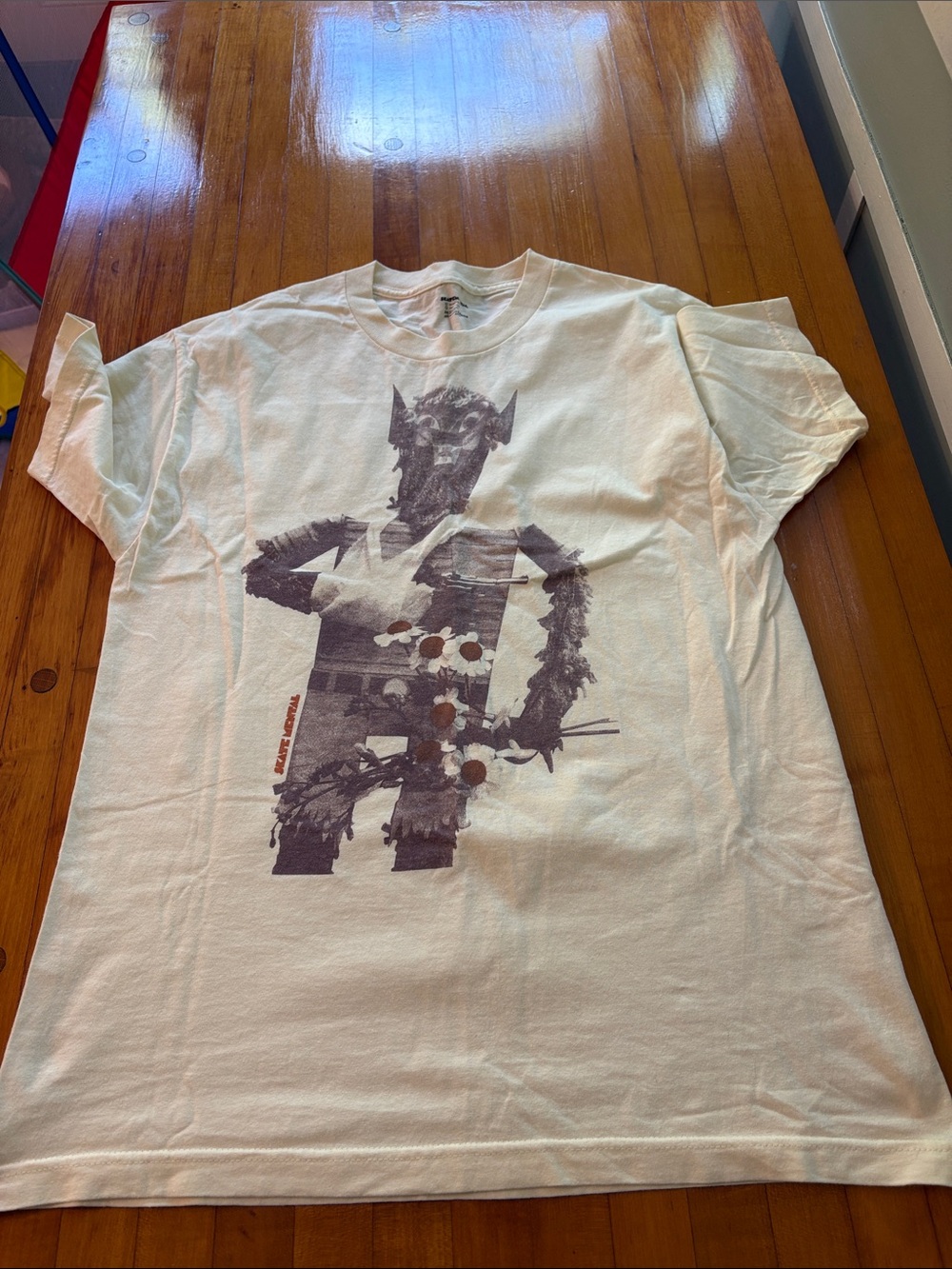 SkateMental Cream Tee with Large Dark Gray Graphic Figure and Subtle Rust Detail